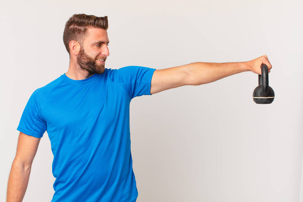 young fitness man lifting a dumbbell - Фото, зображення
