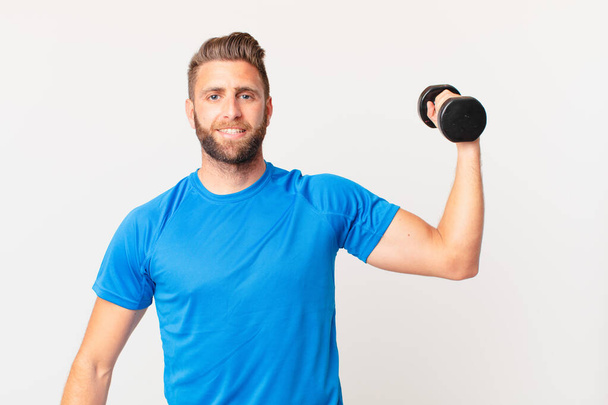 young fitness man lifting a dumbbell - Φωτογραφία, εικόνα