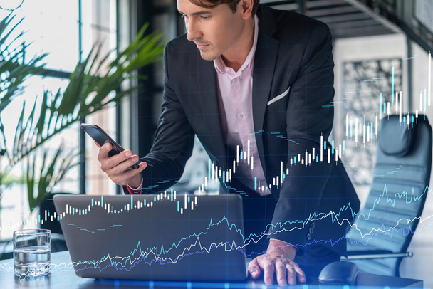 Businessman in suit using smart phone to optimize trading strategy at corporate finance fund. Forex chart hologram over modern panoramic office background - Foto, Bild