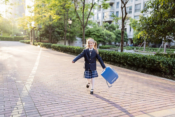 Back to school. Little girl from elementary school outdoor. Kid going learn new things 1th september - Photo, Image