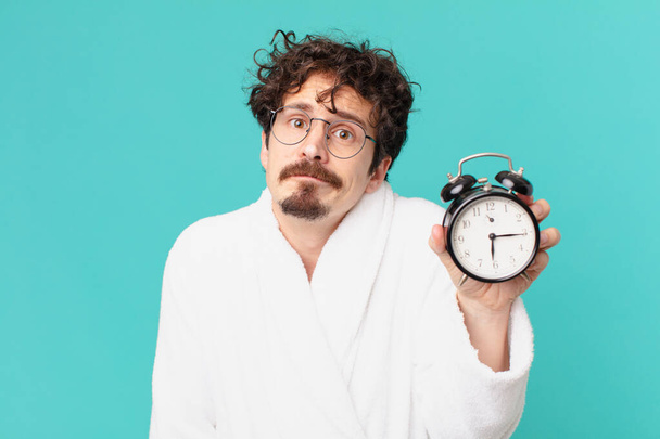 young crazy man with an alarm clock - Foto, Bild