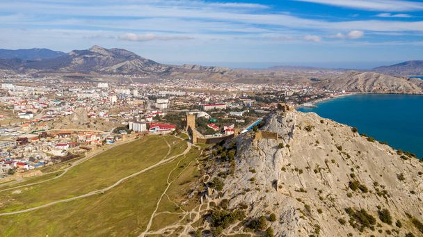 Mountain fortress (Genoese Fortress). Genoese Fortress is located in Sudak, Coast of the Crimea peninsula, rocky mountains, aerial view of the sea resort Sudak - Photo, Image