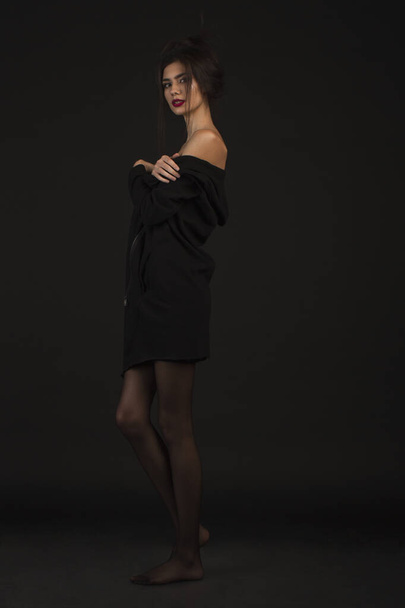 beautiful girl in panties and black stockings on a dark background - Фото, зображення