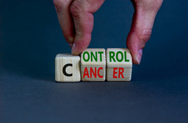 Control cancer symbol. Doctor turns wooden cubes with words 'Control cancer'. Beautiful grey background. Control cancer and medical concept. Copy space. - Foto, immagini