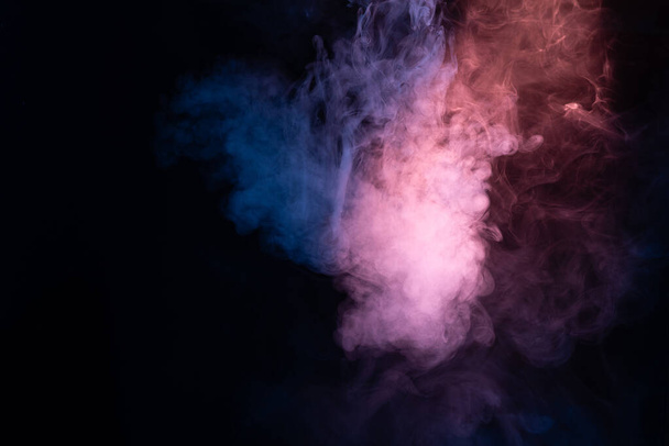 Blue and pink steam on a black background. Copy space. - Photo, image