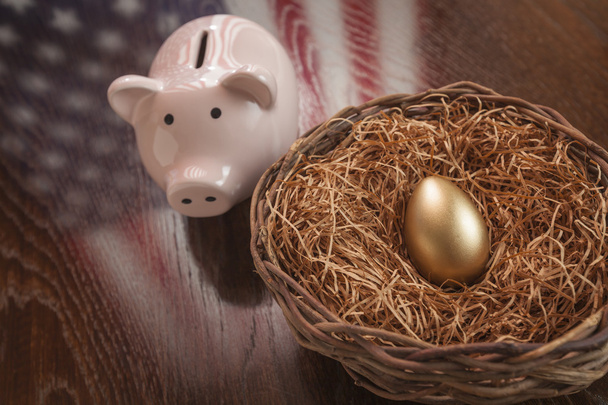 Golden Egg, Nest and Piggy Bank with American Flag Reflection - Photo, Image