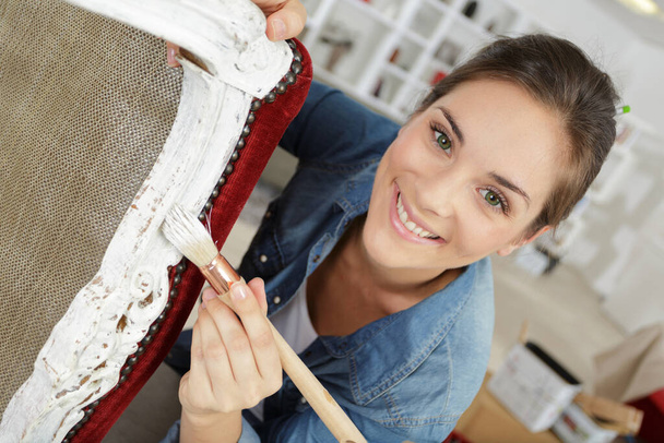 woman painting a chair at home - 写真・画像