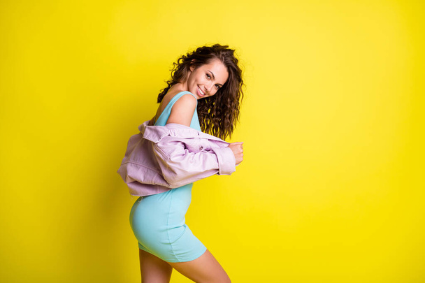 Photo of happy smiling flirty coquettish stunning gorgeous girl in short dress lilac jacket isolated on yellow color background - Foto, Imagen