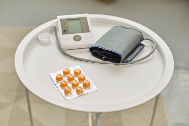 Hypertension, medical care medication pills. Medicines and blood pressure monitor on table. Medicine and healthy lifestyle - Fotó, kép