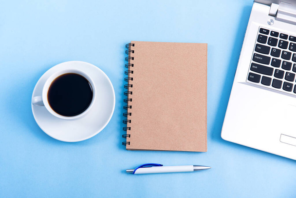 notebook with notepad and cup of coffee on tabl - Fotografie, Obrázek