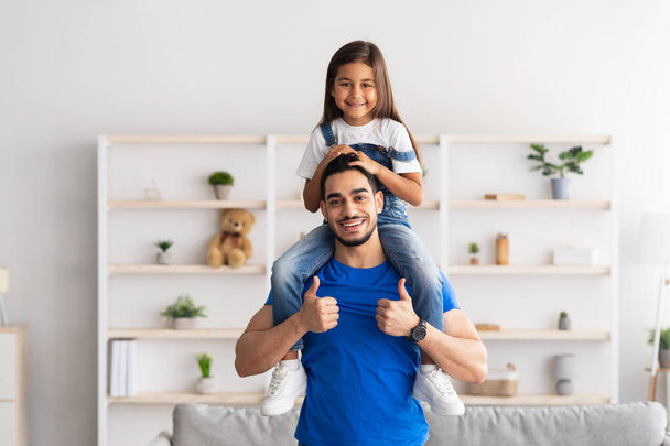 Cheerful Man Riding Excited Daughter On His Shoulders - Photo, image