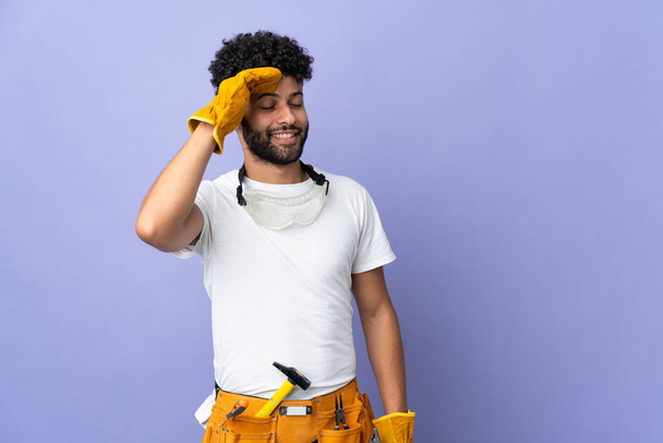 Young electrician Moroccan man isolated on purple background smiling a lot - Foto, Bild