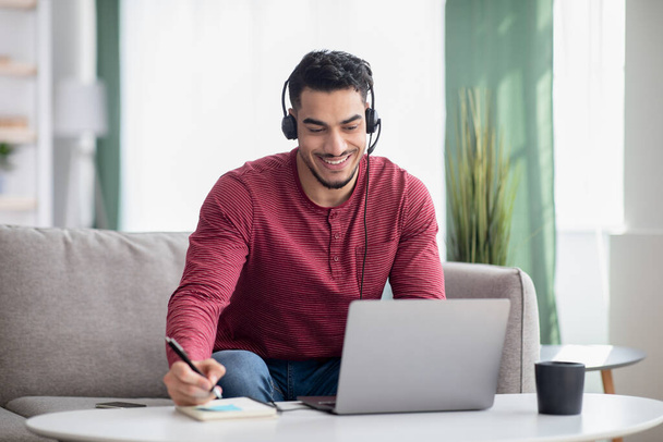 Happy arab guy attending online training from home - Photo, Image
