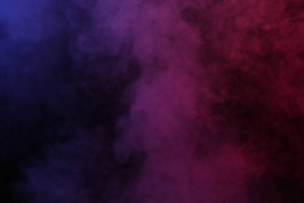 Smoke in red-blue light on black background - Photo, Image