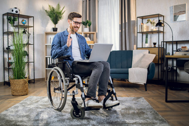 Disabled man having video conference on laptop - Φωτογραφία, εικόνα