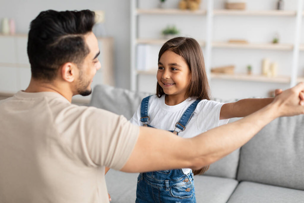 Dad and daughter dancing in living room together - Photo, Image