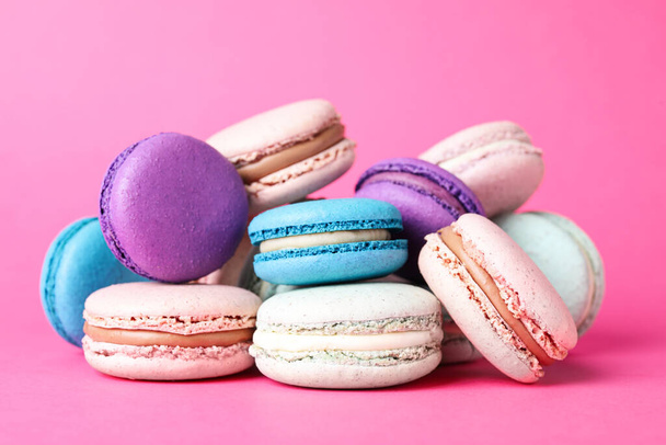 Pile of delicious colorful macarons on pink background - Fotografie, Obrázek