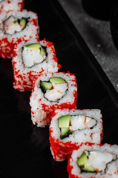 sushi roll california with shrimp, avocado and cheese. Traditional japanese sushi. - Zdjęcie, obraz