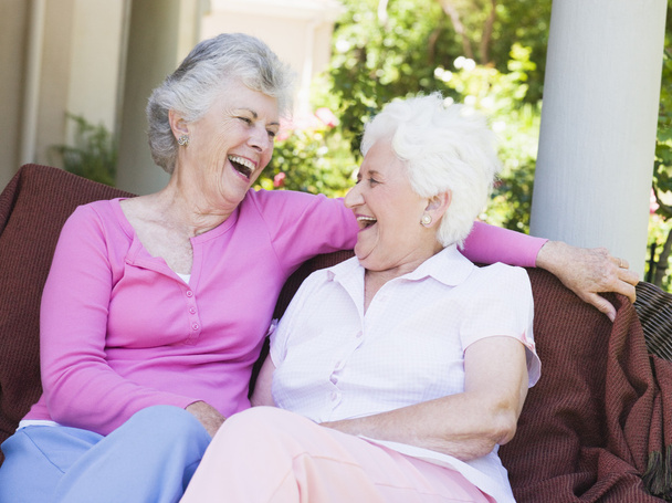 Senior female friends laughing together - Foto, afbeelding