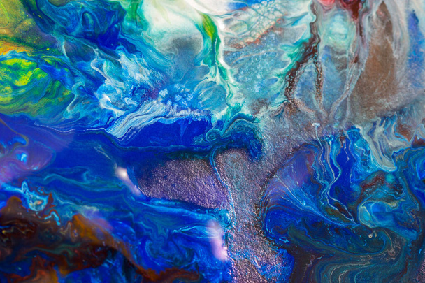 Ein abstrakter Hintergrund mit bunten Farbspritzern und wirbelnden Texturen - Foto, Bild