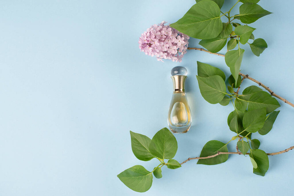 YEREVAN, ARMENIA - May 30, 2021: Dior perfume on the light blue background with flowers and leaves. Beautiful design and feminine fragrance for women. - Фото, зображення