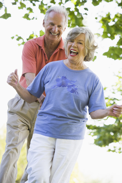 Senior couple having fun outside in park - Фото, изображение