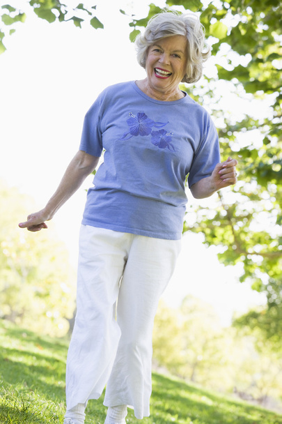 Senior woman exercising in park - Zdjęcie, obraz