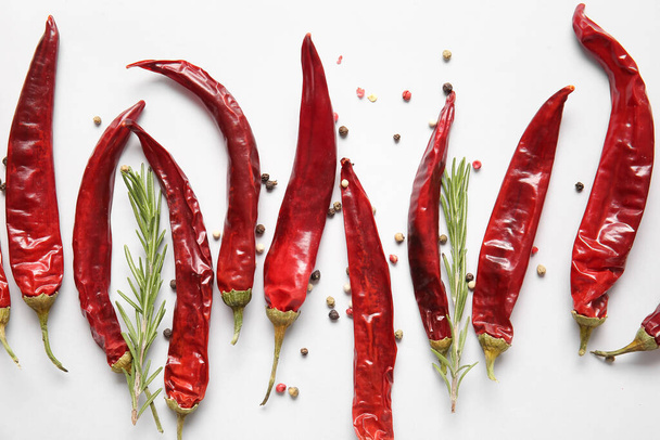 Dry hot chili peppers and spices on white background - Foto, Imagen