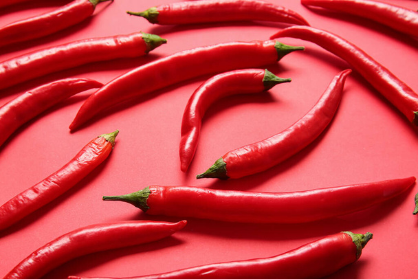 Hot chili peppers on color background - Photo, Image