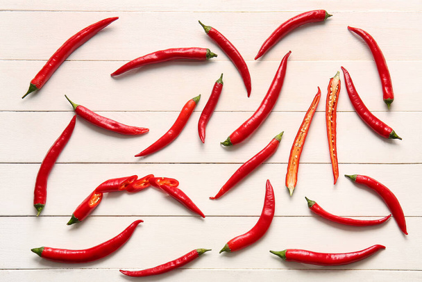 Hot chili peppers on white wooden background - Photo, Image
