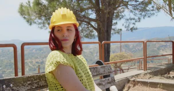 Outdoor footage of beauty Italian architect in yellow helmet. Young woman in construction side at daytime  - Metraje, vídeo