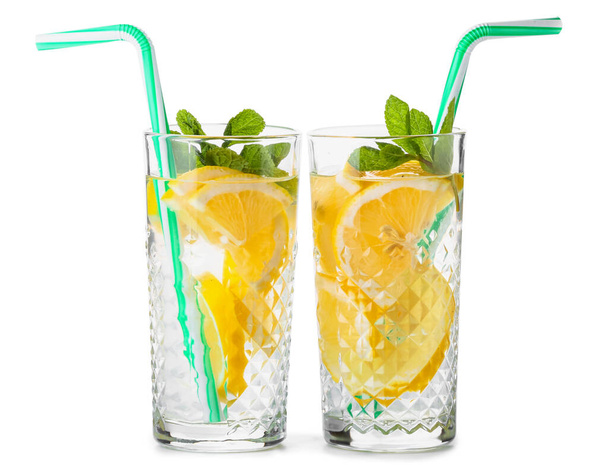 Glasses of tasty cold lemonade on white background - Photo, Image