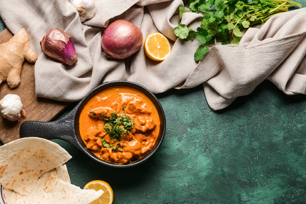 Frying pan of tasty chicken tikka masala on color background - Photo, Image