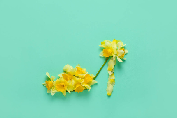 Female shoes made of beautiful daffodils on color background - Foto, afbeelding