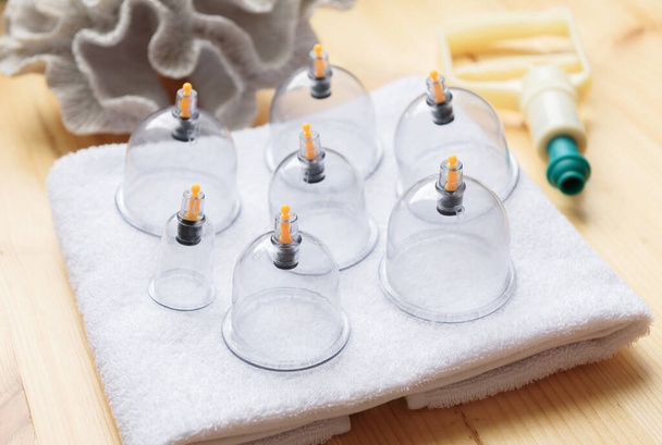 Jars for hijama on wooden table background, copy space. Bloodletting. Sunnah treatment. Vacuum therapy - Fotoğraf, Görsel