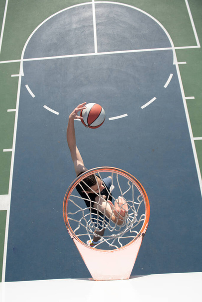 Caucasian basketball player of team in action, motion in jump. Concept of sport, movement, energy and dynamic, healthy lifestyle. Training, practicing. - Photo, Image