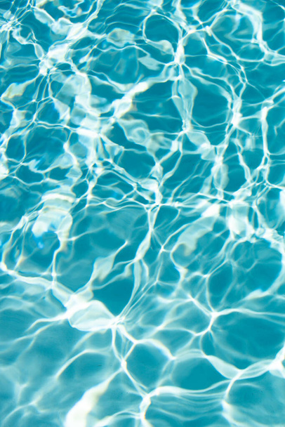 Ripped water in swimming pool. Surface of blue swimming pool, background of water. - Фото, изображение
