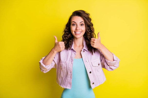 Portrait of pretty cheerful glad wavy-haired girl showing double thumbup cool isolated over bright yellow color background - Фото, зображення