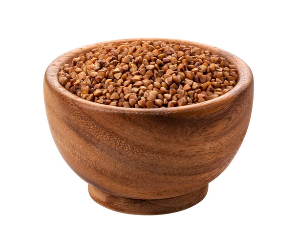 Buckwheat groats in wooden bowl isolated on white background with clipping path - Photo, Image