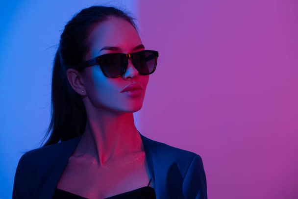 Fashion woman in glowing neon light. Red purple and blue color - Photo, Image