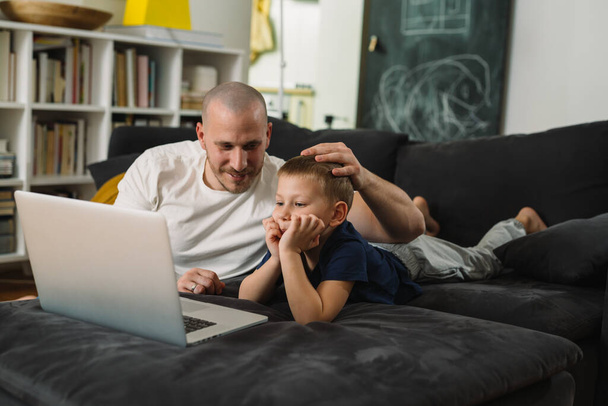 father and son using laptop at home - Valokuva, kuva