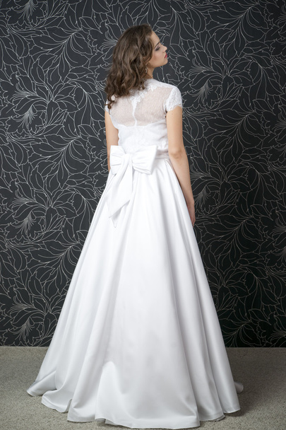 Beautiful woman in white wedding dress with corset - 写真・画像
