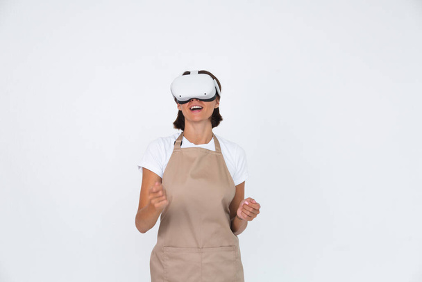 Housewife in apron isolated on white background in vr glasses cooking making dinner play games - Φωτογραφία, εικόνα