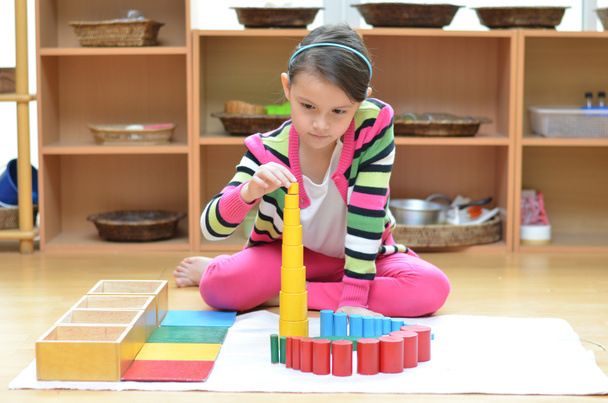 Little girl hand building tower made of montessori educational m - Photo, Image