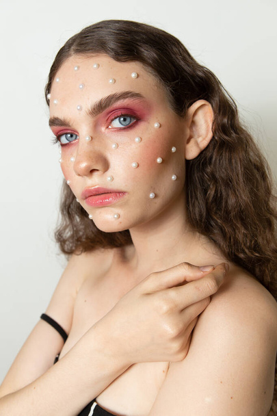 Kreativní portrét dívky s čistou pletí a make-upem a účesem - Fotografie, Obrázek