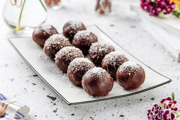 Plate of sweet chocolate balls with coconut - Photo, Image