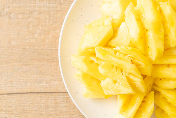 fresh pineapple sliced on white plate - Foto, imagen