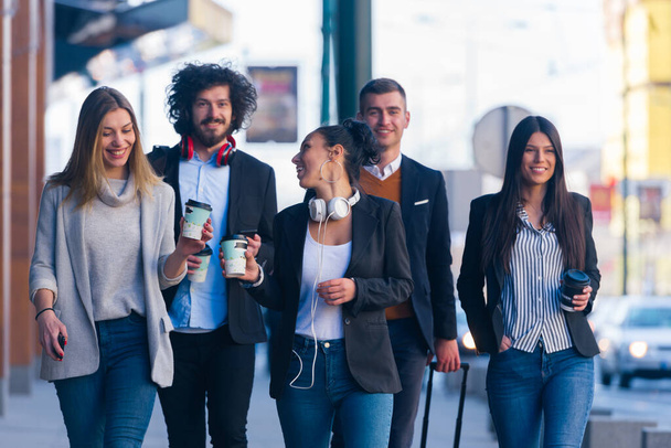 Group of diverse coworkers walking together, smiling and express - Photo, Image