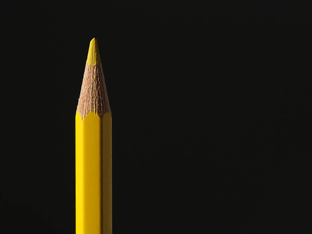 yellow pencil on a black background - Photo, Image