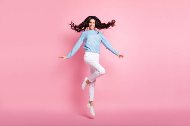 Full size photo of pretty positive person jumping flying hair have good mood isolated on pink color background - Фото, изображение